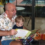 Papa reads Petite Rouge Riding Hood to Alex.